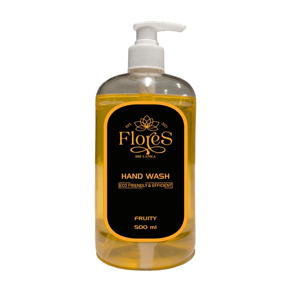 A 500ml clear pump bottle of Flores Eco handwash with a yellow label, under the sink, indicating fruity scent.
