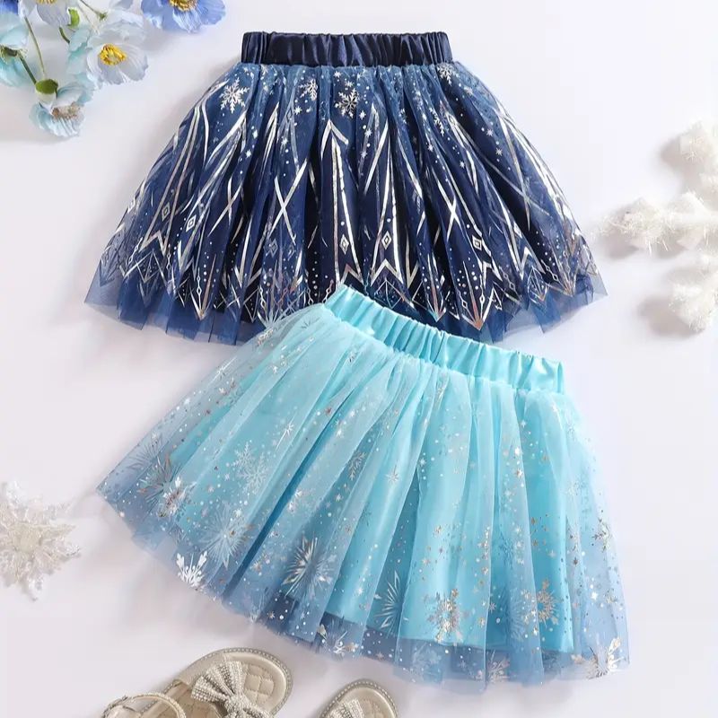 Two tutu skirts, one blue and one navy, with snowflake patterns on a white background.
