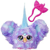 A small plush toy resembling a Furby with purple and blue fur, big eyes, and a pink accessory on its head.