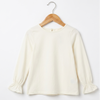 An off-white long-sleeve blouse with gathered cuffs, hanging on a wooden hanger against a plain white background.