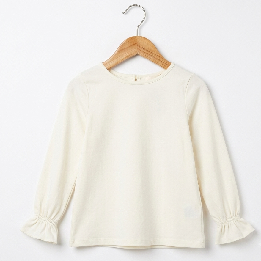 An off-white long-sleeve blouse with gathered cuffs, hanging on a wooden hanger against a plain white background.