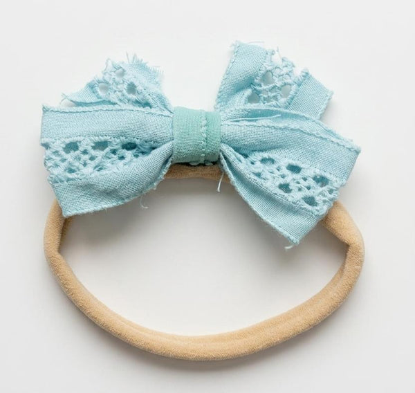 Light blue bow headband on a white background