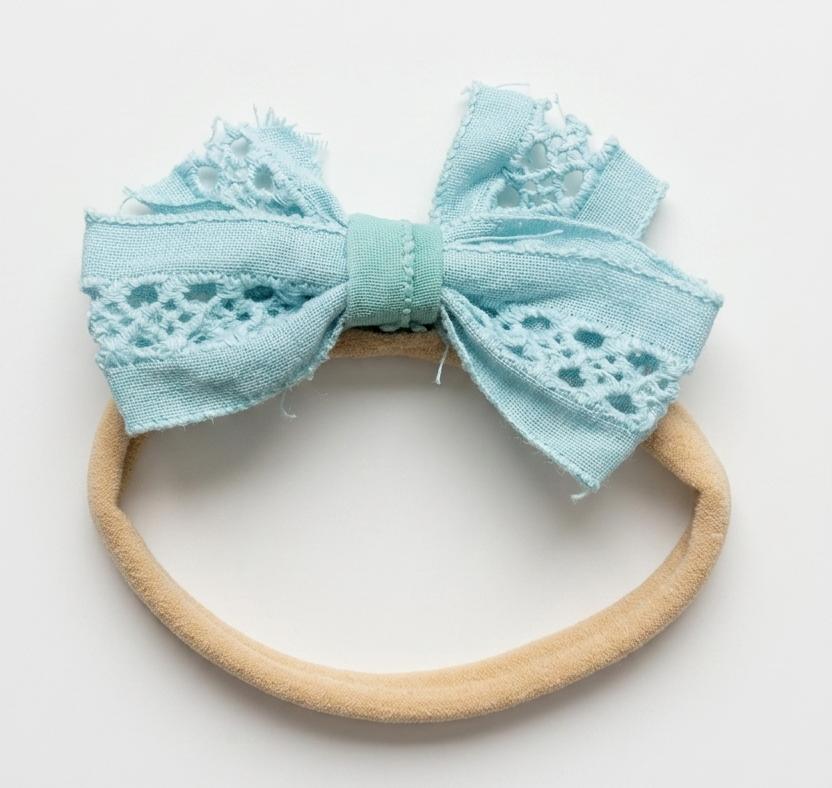 Light blue bow headband on a white background