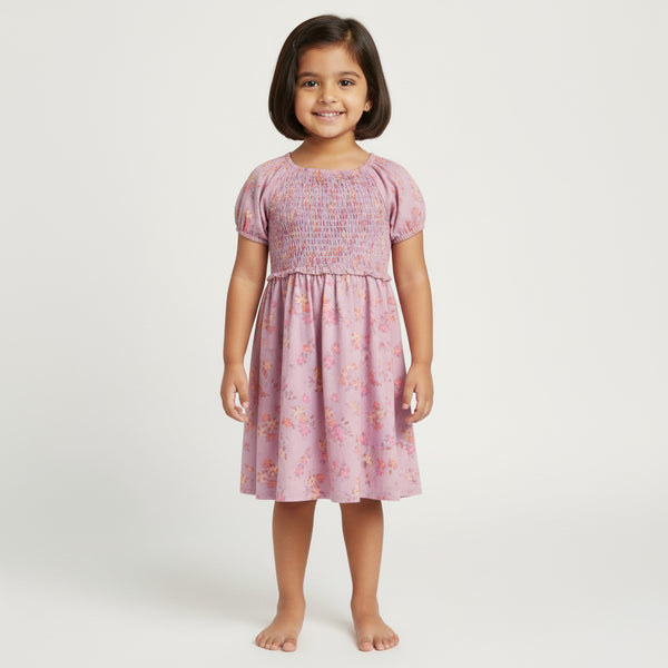 Young girl wearing a pink floral dress on a white background