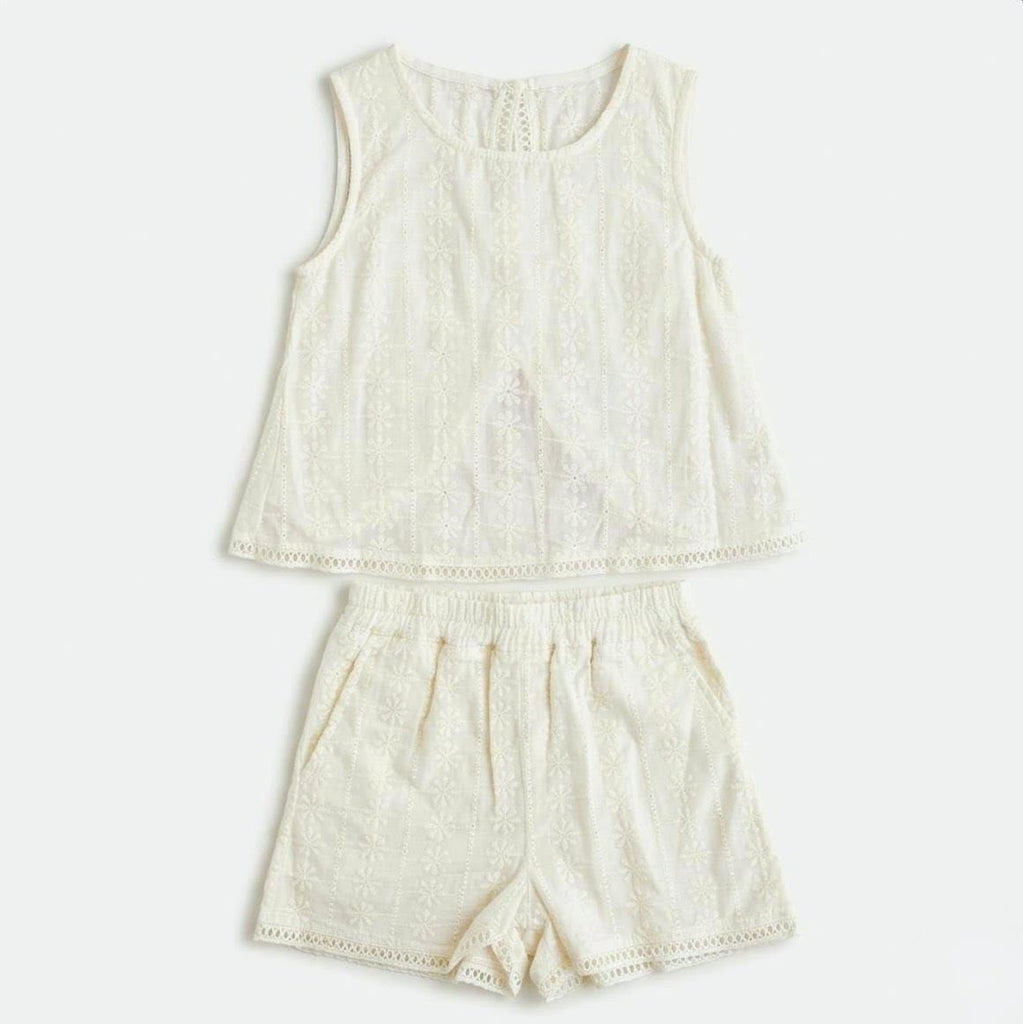 Cream-colored sleeveless top and shorts set on a white background