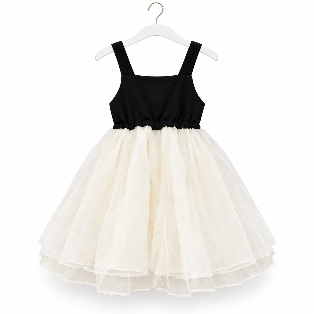 A toddler girl's sleeveless party dress with a black bodice and a voluminous cream tulle skirt, hanging on a white hanger against a white background.