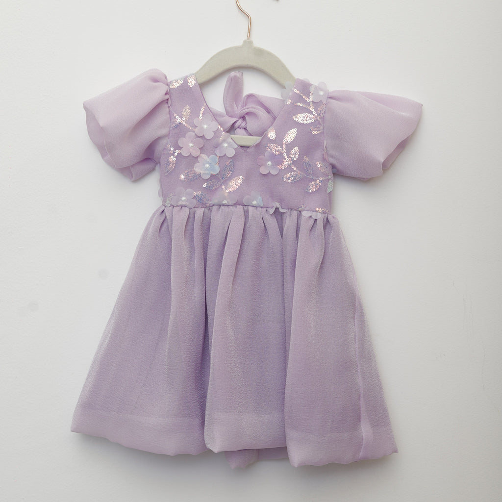 Lavender dress with floral embroidery on a white background