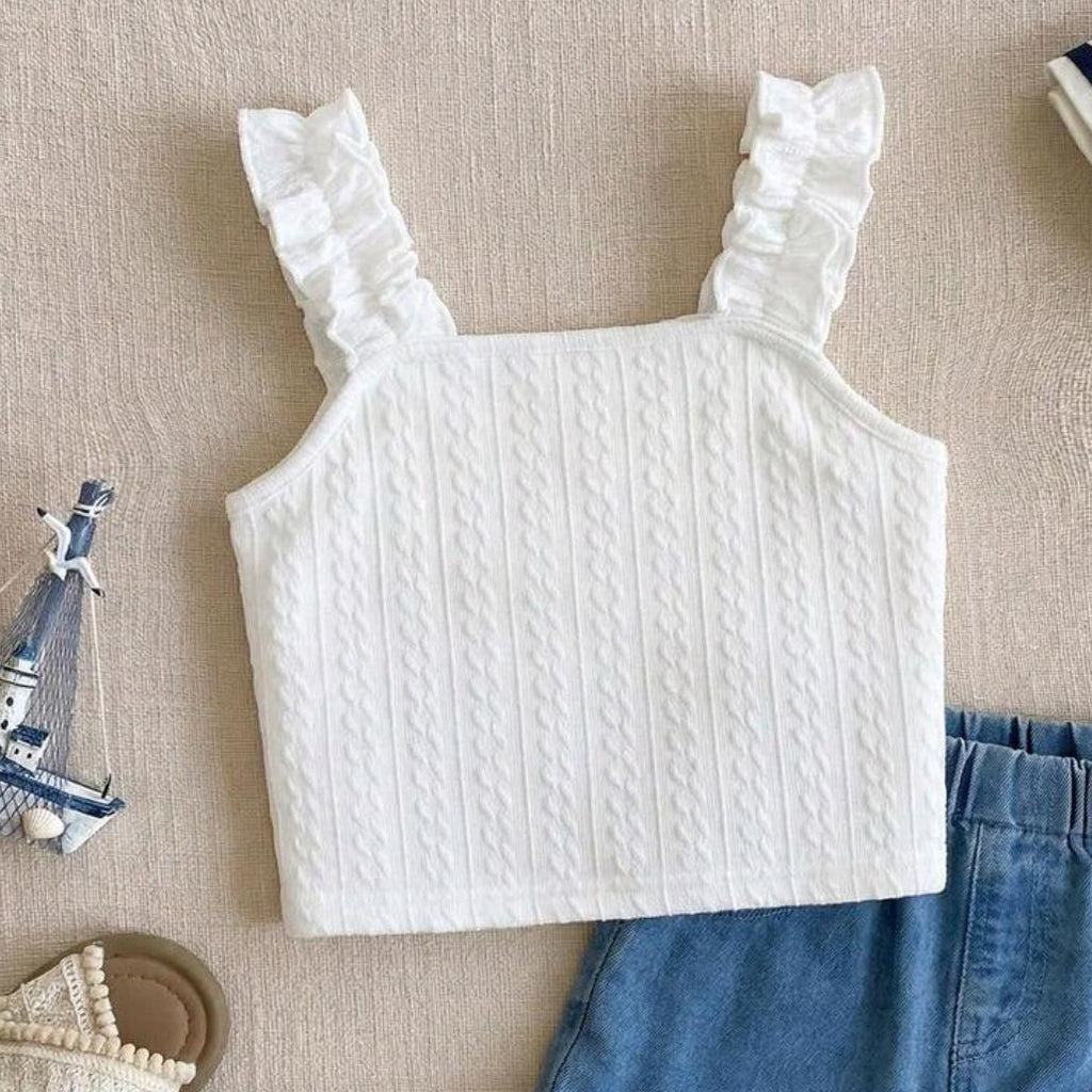 White textured top with ruffled straps on a beige surface