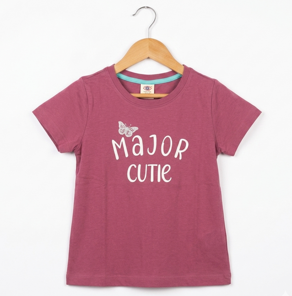 Pink t-shirt with 'Major Cutie' text on a wooden hanger against a white background
