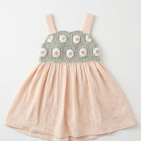 Pink dress with floral crochet top on a light gray background