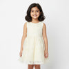 Young girl wearing a white lace dress against a plain background