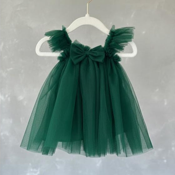 Green tulle dress with a bow on a white hanger against a light gray background