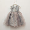 Children's dress with sequined top and tulle skirt on a hanger against a white background