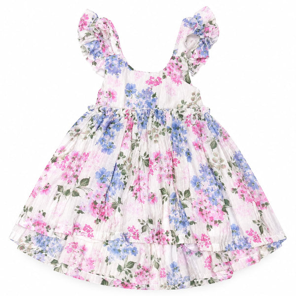 A toddler girl's tiered dress with a pink and blue floral print on a white background, featuring ruffled shoulder straps and a gathered waist.