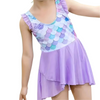 Child wearing a colorful mermaid scale dress with a purple skirt on a white background