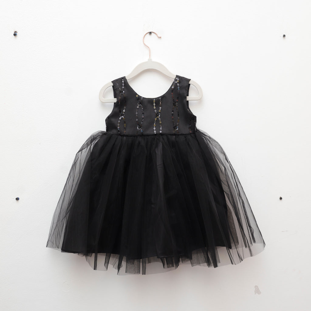 Black dress with sequin top on a white hanger against a white background