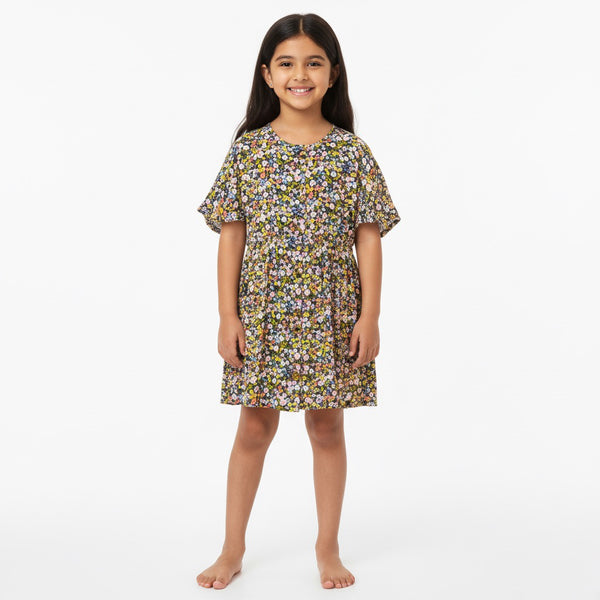 Young girl wearing a floral dress on a white background