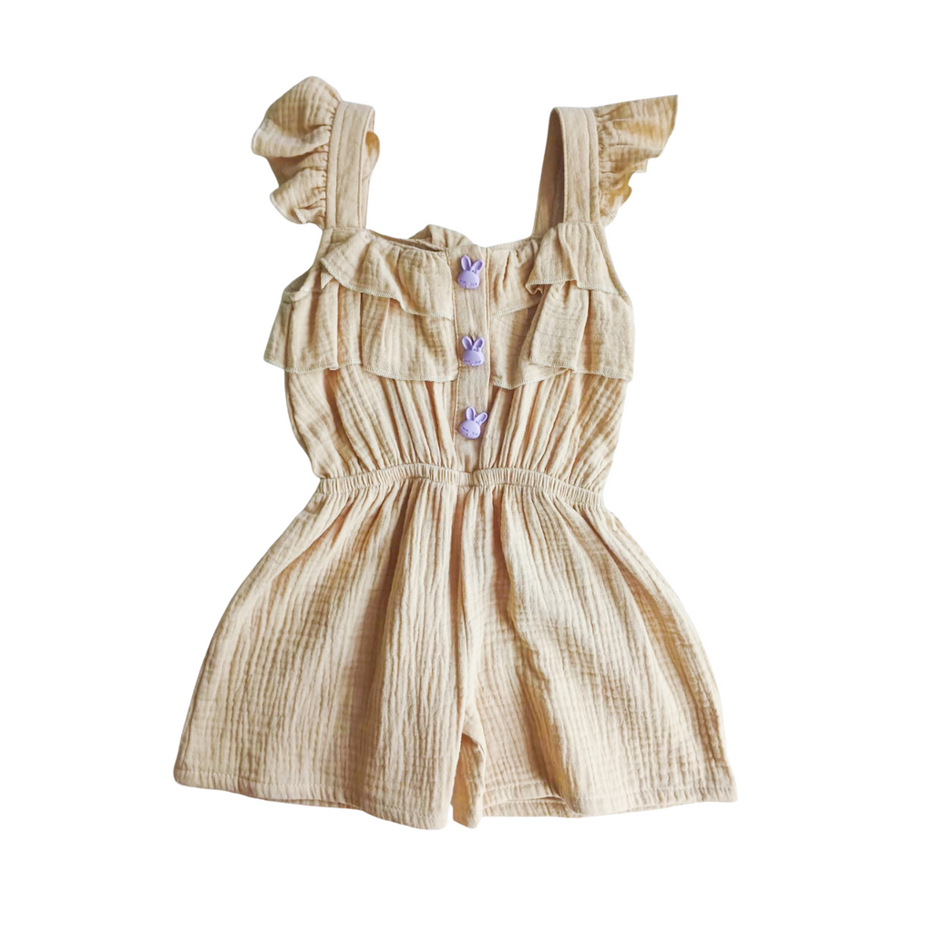 Beige romper with ruffled straps and buttons on a white background