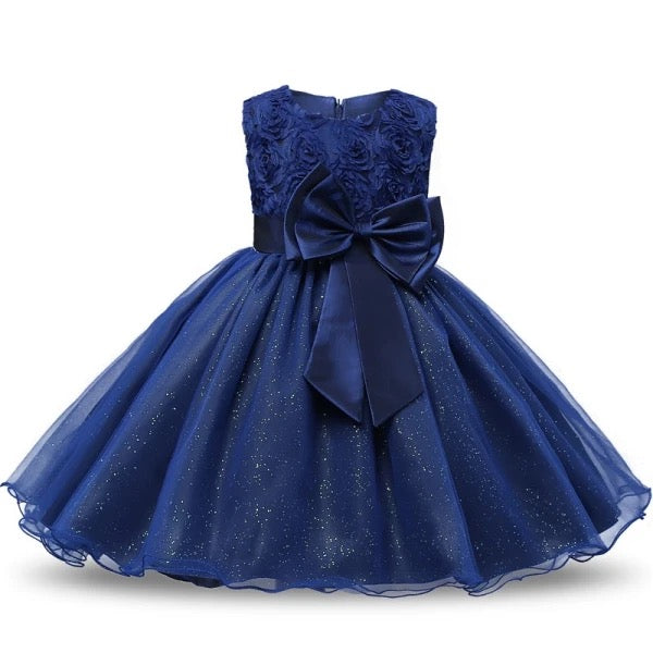 Navy blue dress with floral top and large bow on a white background