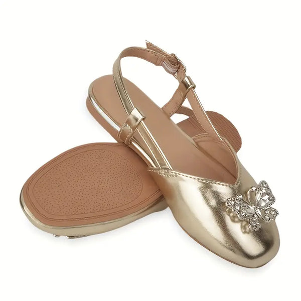 Gold flat sandal with a decorative bow on a white background