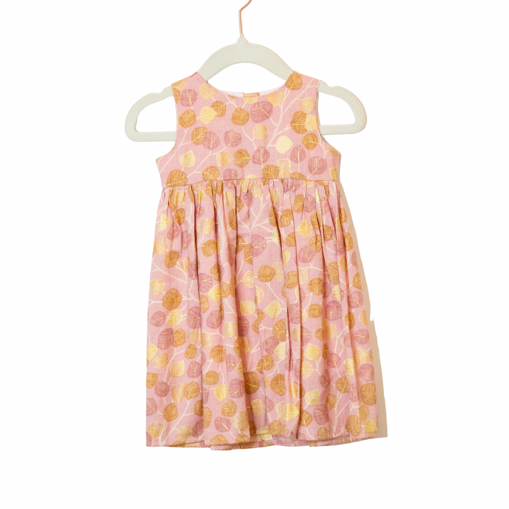 Pink dress with yellow floral pattern on a white hanger