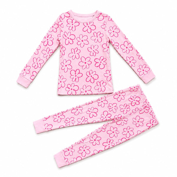A two-piece children's pajama set featuring a long-sleeve top and matching pants in light pink with a darker pink floral pattern, laid flat on a white background.