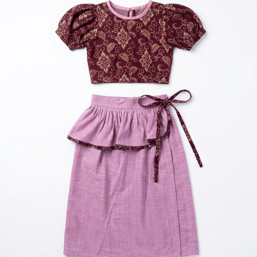 Purple top and skirt set with floral pattern on a white background