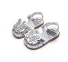 Silver children's sandals with butterfly designs on a white background