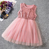 A sleeveless pink party dress for girls, with sequin detailing on the top and a tulle skirt.
