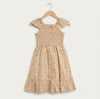A toddler girl's sleeveless dress with ruffled cap sleeves and a tiered hem, featuring a beige base with a delicate orange and green floral pattern, hanging on a wooden hanger against a light off-white background.