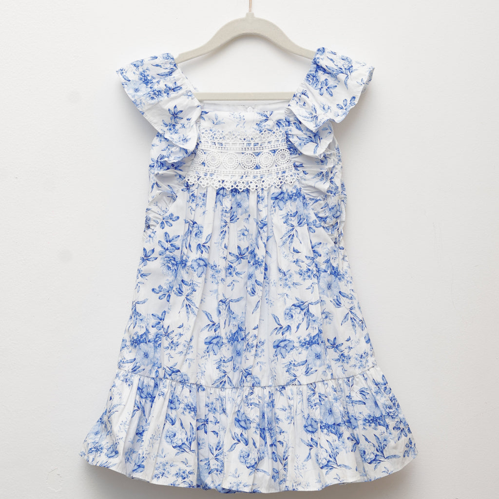 Blue floral dress on a white hanger against a light gray background