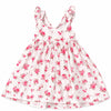A sleeveless white dress with a pink and green floral print, featuring ruffled shoulder straps and a gathered skirt, shown flat against a white background.