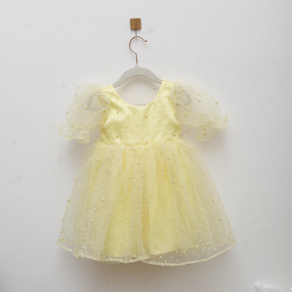 Yellow dress with polka dots on a white background