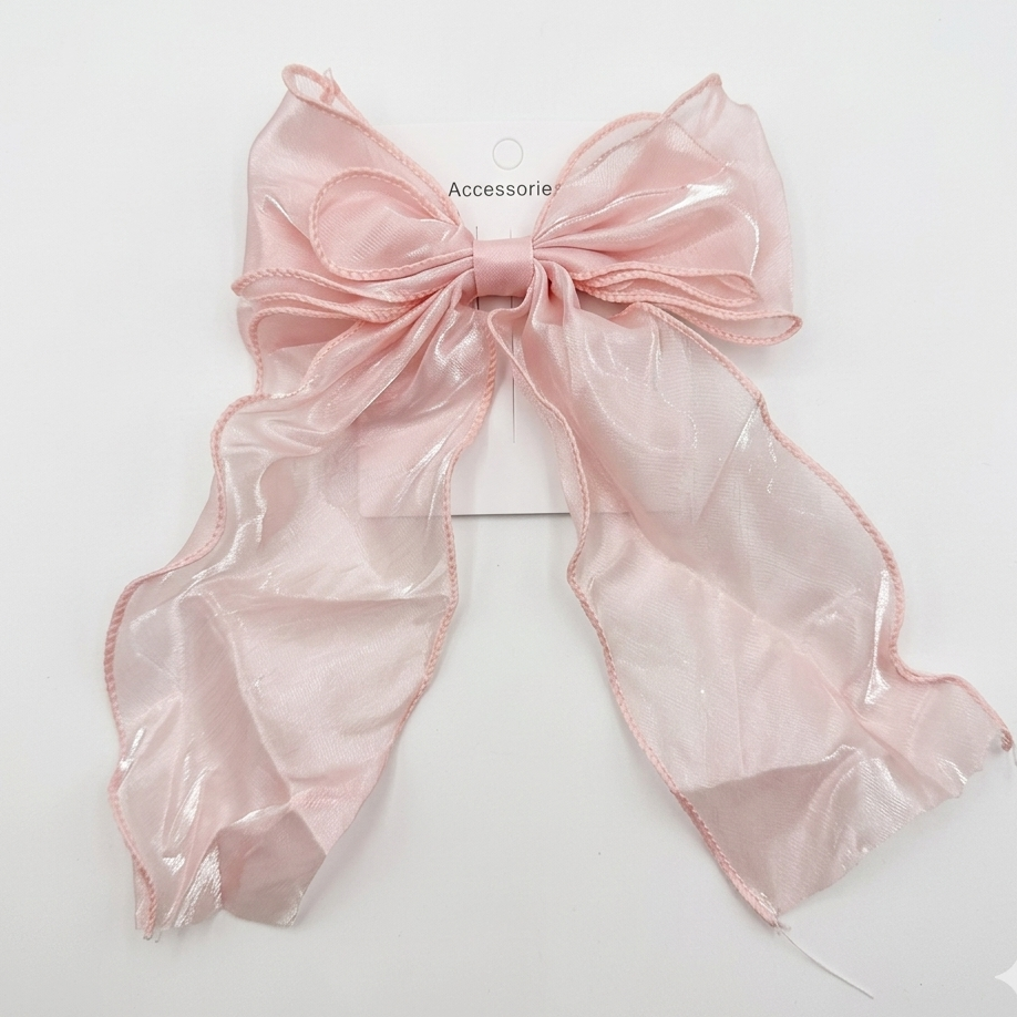 Pink bow accessory on a white background
