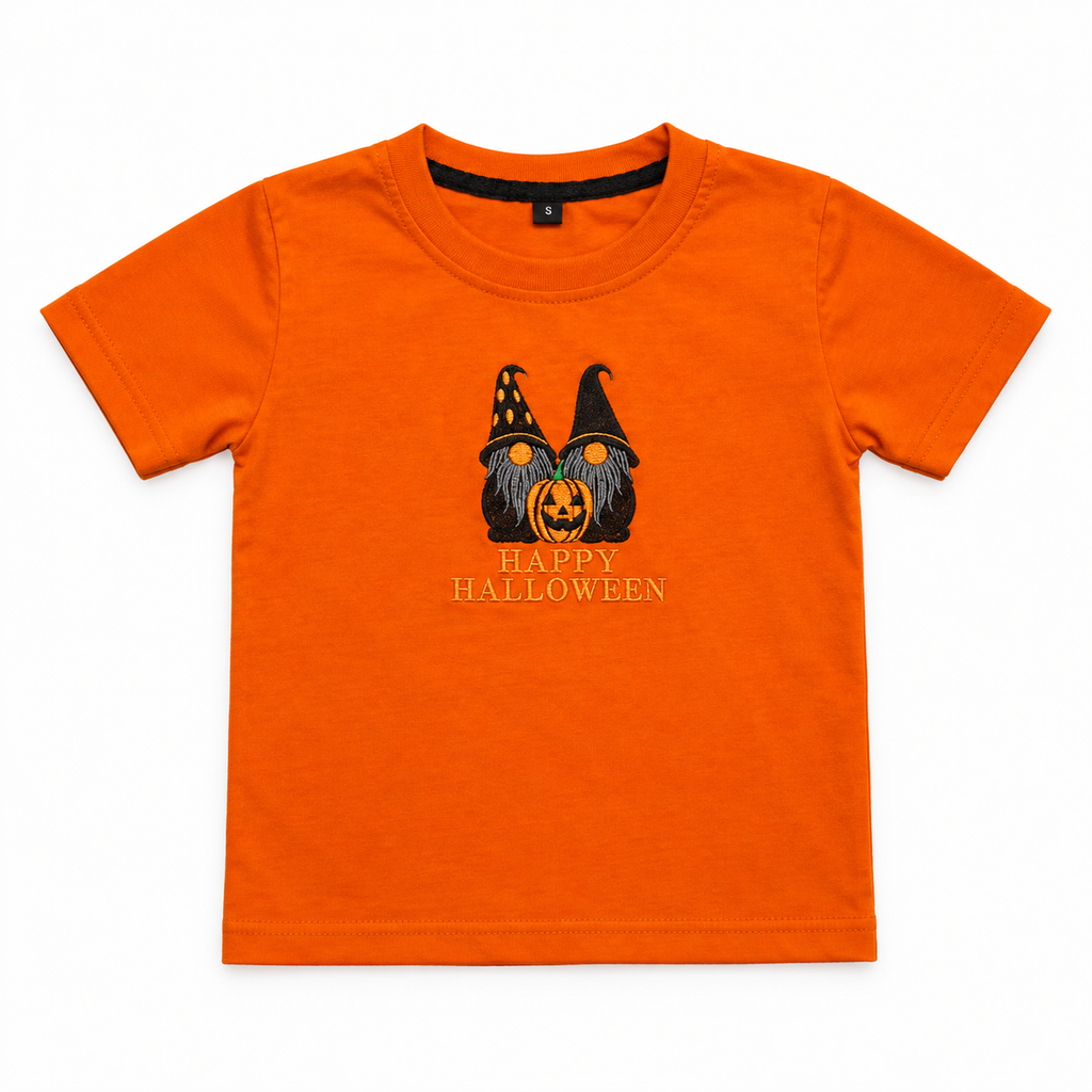 A bright orange short-sleeve kids' t-shirt with a Halloween graphic of two gnome faces behind a jack-o'-lantern and the text 'HAPPY HALLOWEEN' printed on the chest.