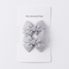 Two gray hair bows on a white card with 'Accessories' text on a light gray background