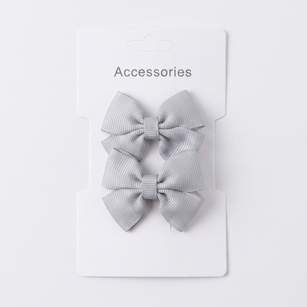 Two gray hair bows on a white card with 'Accessories' text on a light gray background