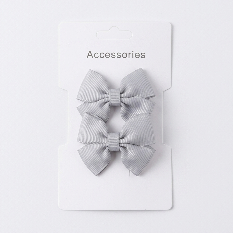 Two gray hair bows on a white card with 'Accessories' text on a light gray background