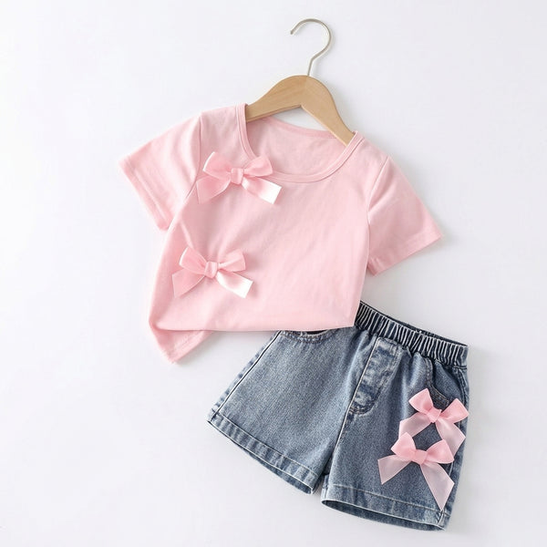 Pink top and denim shorts with pink bows on a white background