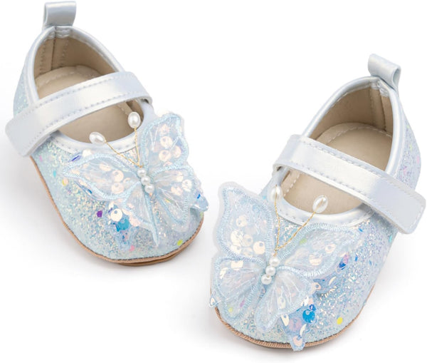 Pair of glittery blue shoes with white bows on a white background