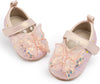 Pair of children's shoes with butterfly designs on a white background