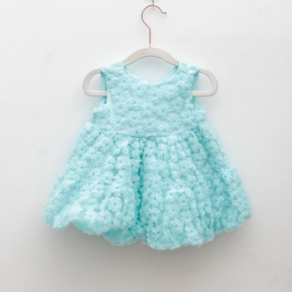 Light blue textured dress on a white hanger against a white background