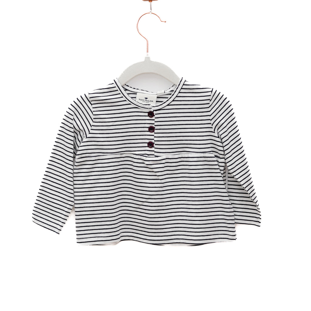 Black and white striped shirt on a hanger against a white background