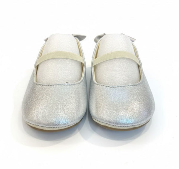 Pair of silver glittery shoes on a white background