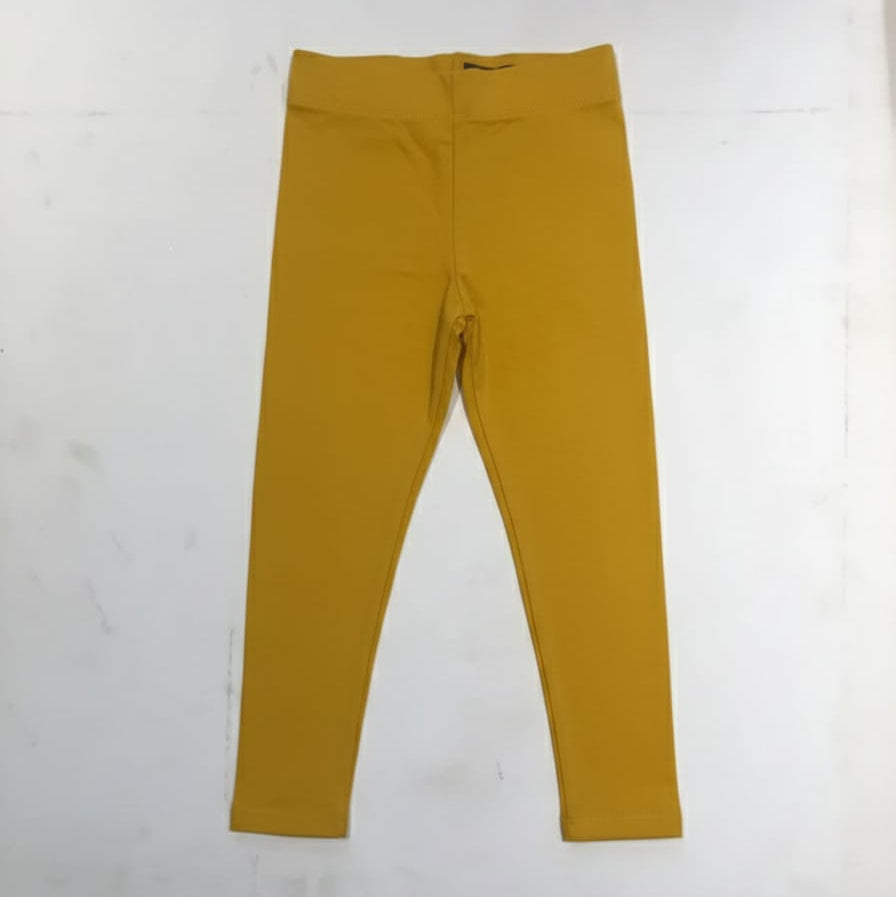 Mustard yellow leggings on a white background