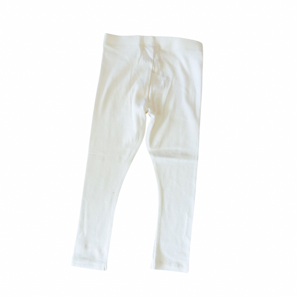 A pair of white leggings for kids, viewed from the side against a white background.