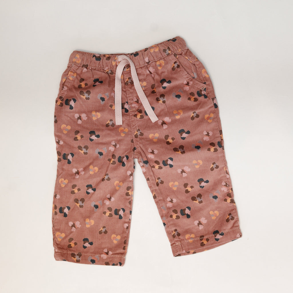 Floral-patterned pants on a light gray background