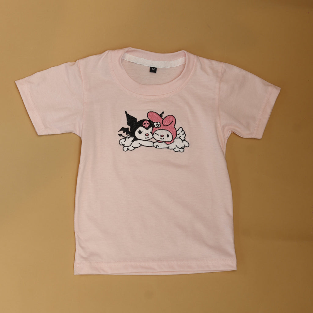 Pink top with cartoon design on a beige background