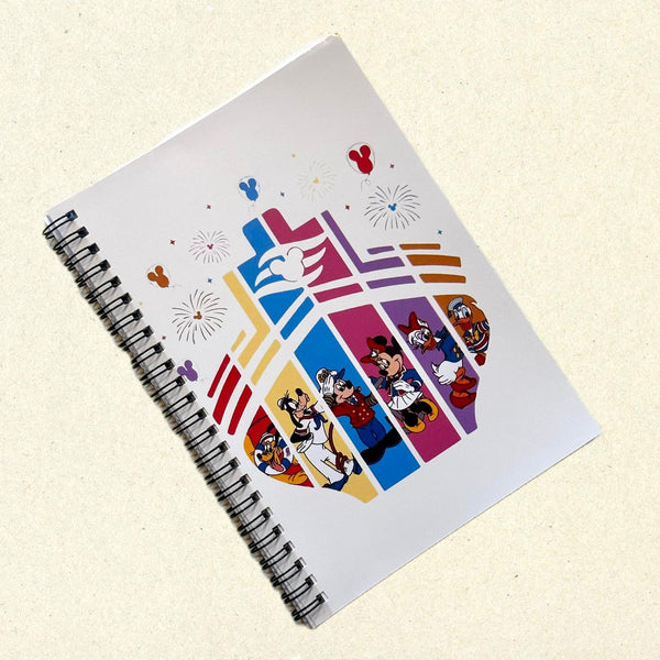 Notebook with colorful character designs on a beige background