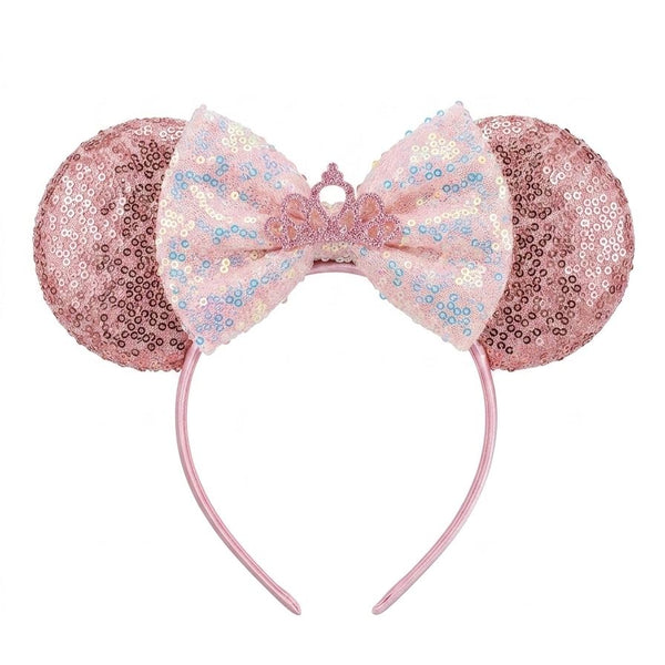 Pink sequin mouse ears with a bow on a white background